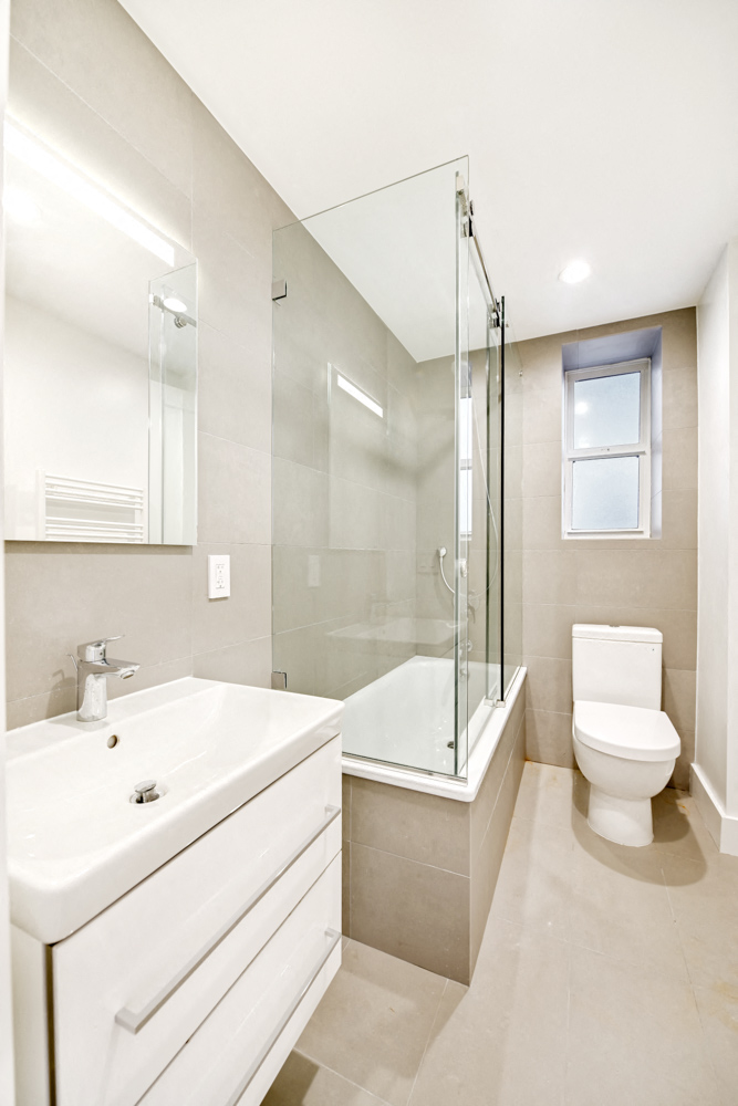 a bathroom with a sink toilet and a shower